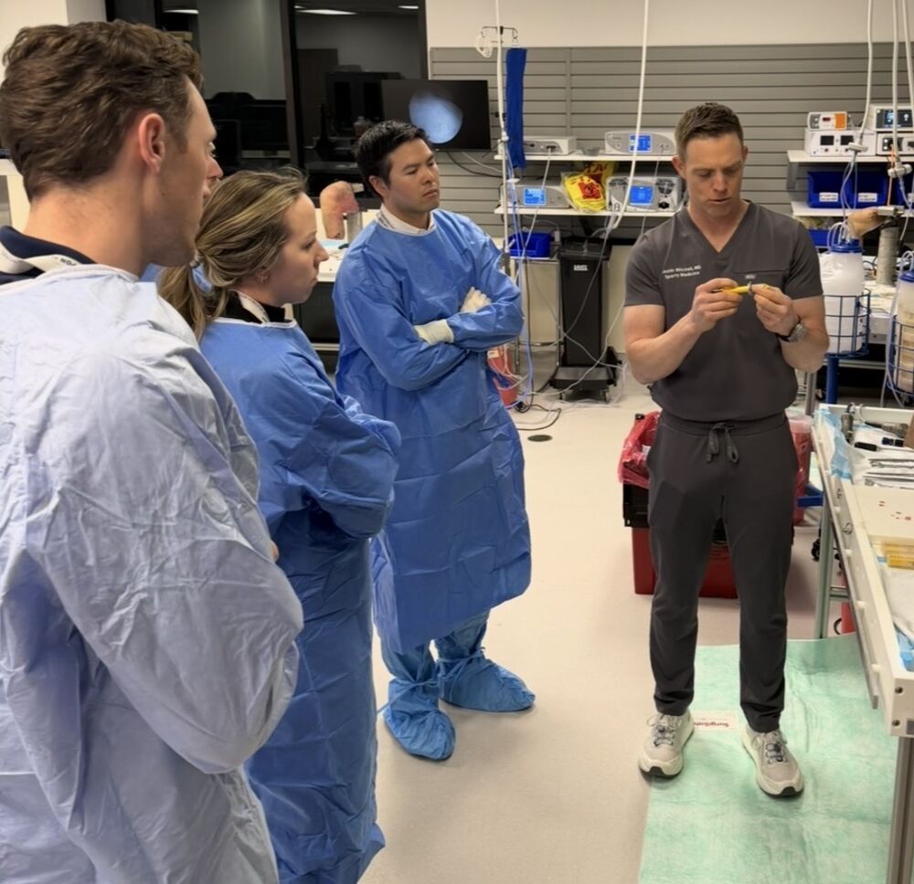 Dr. Mitchell teaching arthroscopic techniques to surgeons in a training lab
